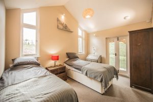 Twin bedroom in The Lake House holiday accommodation South Wales